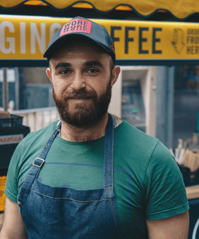 Barista standing next to Change Please coffee cart