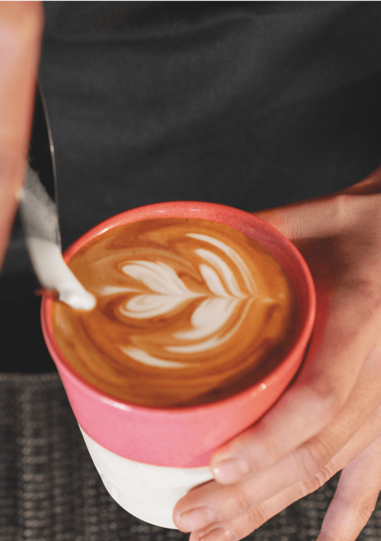 Barista pouring latte