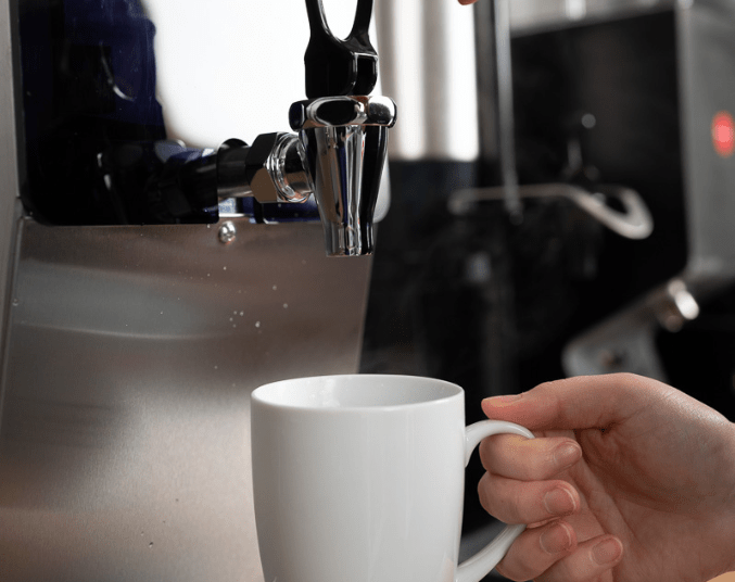 mug being held near a commercial boiler