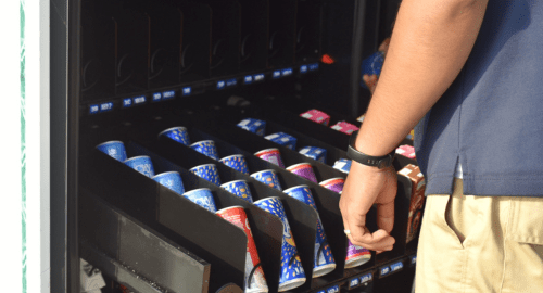 Someone stocking up a vending machine