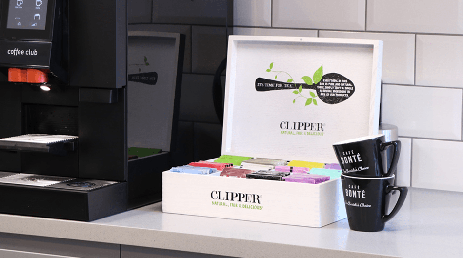 clipper tea display box next to a commercial coffee machine