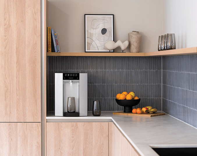 borg & overstrom water dispenser in a commercial kitchen setting with wooden cabinets and blue backsplash