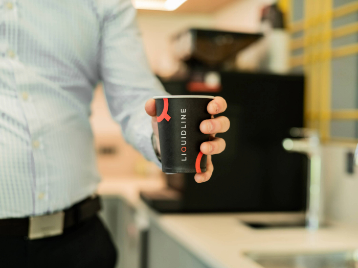 Liquidline paper cup being held