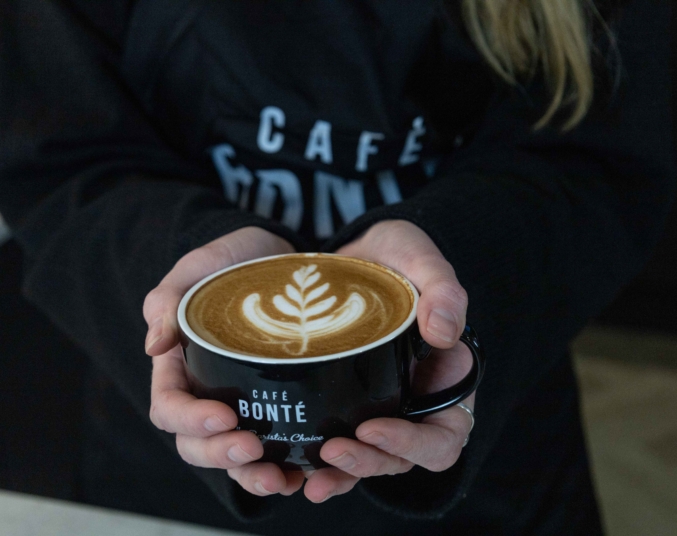 Coffee art being shown off between two hands